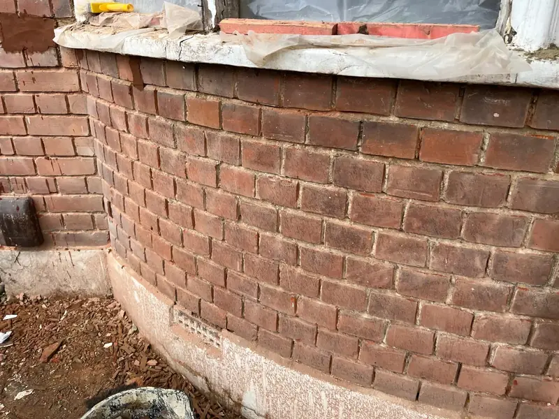 Before — stained and poorly pointed brickwork, Enfield
